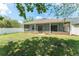 Large backyard features a screened-in patio, lush grass, and white picket fence at 3752 Cleary Way, Orlando, FL 32828