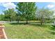 Backyard with manicured lawn, privacy fence, and scenic pond backdrop at 3752 Cleary Way, Orlando, FL 32828