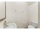 A half bathroom featuring a toilet and sink with silver fixtures at 3752 Cleary Way, Orlando, FL 32828