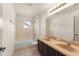 Bathroom has tile floor, double sink vanity, bathtub, and shower with neutral wall color at 3752 Cleary Way, Orlando, FL 32828