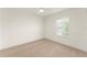Bright bedroom featuring neutral carpet, a ceiling fan, and a large window at 3752 Cleary Way, Orlando, FL 32828