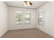 Bedroom featuring neutral carpet, white walls, a ceiling fan, and three windows at 3752 Cleary Way, Orlando, FL 32828