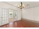Open dining area with hardwood floors and glass doors, offering seamless access to other rooms at 3752 Cleary Way, Orlando, FL 32828