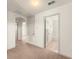 Hallway with neutral carpet has white walls and trim, with doorways leading to other rooms at 3752 Cleary Way, Orlando, FL 32828