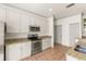 The modern kitchen is equipped with stainless steel appliances and elegant granite countertops at 3752 Cleary Way, Orlando, FL 32828