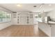 Spacious living room with tile floors and a custom built-in entertainment center, flowing into a bright kitchen at 3752 Cleary Way, Orlando, FL 32828