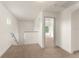Bright loft area features neutral carpet, white walls, and a view into another room of the home at 3752 Cleary Way, Orlando, FL 32828
