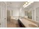 Main bathroom with a separate shower, a soaking tub, and a long granite-topped vanity with dual sinks at 3752 Cleary Way, Orlando, FL 32828