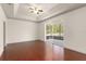 Main bedroom with hardwood floors, tray ceiling, and sliding glass doors to a screened lanai at 3752 Cleary Way, Orlando, FL 32828