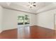 Spacious main bedroom featuring hardwood floors, a tray ceiling, and access to a screened patio at 3752 Cleary Way, Orlando, FL 32828