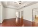 Main bedroom with hardwood floors and multiple doorways, including access to a bathroom and walk-in closet at 3752 Cleary Way, Orlando, FL 32828