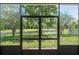 The screened-in patio offers serene views of the backyard and pond at 3752 Cleary Way, Orlando, FL 32828