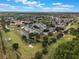 An aerial view captures the expansive community surrounded by lush greenery, a golf course, and scenic waterways at 3780 Ventura Cove Dr, Orlando, FL 32822