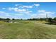 Expansive manicured lawn with a view of the golf course and surrounding area at 3780 Ventura Cove Dr, Orlando, FL 32822