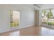 A bright bedroom with laminate floors and plenty of natural light from two large windows at 3780 Ventura Cove Dr, Orlando, FL 32822