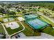 Aerial view of the community amenities including tennis courts, shuffleboard, playground, and green spaces at 3780 Ventura Cove Dr, Orlando, FL 32822