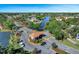Gated community entrance showcasing meticulous landscaping, a tile-roofed guardhouse, and views of the surrounding lake at 3780 Ventura Cove Dr, Orlando, FL 32822