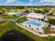 Aerial view of the community clubhouse with a large pool, sundeck, and meticulously manicured grounds at 3780 Ventura Cove Dr, Orlando, FL 32822