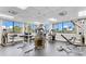 Well-lit gym equipped with a variety of weight machines and large windows showcasing the outdoor scenery at 3780 Ventura Cove Dr, Orlando, FL 32822