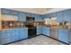 The kitchen features light blue cabinets, stainless steel appliances, and backsplash with decorative tiles at 3780 Ventura Cove Dr, Orlando, FL 32822