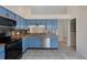 Renovated kitchen featuring blue cabinets, stainless steel appliances, and tile flooring at 3780 Ventura Cove Dr, Orlando, FL 32822