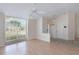 Bright living room featuring laminate floors, ceiling fan, and large windows for natural light at 3780 Ventura Cove Dr, Orlando, FL 32822