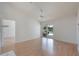 Living room with wood floors and sliding glass doors leading to outdoor pool area at 3780 Ventura Cove Dr, Orlando, FL 32822