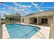 Inviting screened-in pool with plenty of sunbathing area and a view of the home's exterior at 3780 Ventura Cove Dr, Orlando, FL 32822