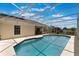 The backyard features a lovely screened-in pool with blue trim and a lounge area at 3780 Ventura Cove Dr, Orlando, FL 32822