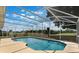 A screened-in pool area with views of lush landscaping and blue skies at 3780 Ventura Cove Dr, Orlando, FL 32822
