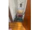 View of basement stairs featuring wood floor and green carpeted steps at 404 E Kentucky Ave, Deland, FL 32724