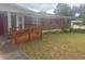 Charming single-story brick home with a wooden ramp leading to the front door at 404 E Kentucky Ave, Deland, FL 32724