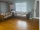 View of the living room with hardwood floors and classic seating arrangements at 404 E Kentucky Ave, Deland, FL 32724