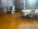 Spacious living room with hardwood floors, a large window, and a dining table at 404 E Kentucky Ave, Deland, FL 32724