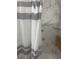 Close up view of shower featuring marble-like walls and a striped curtain at 404 E Kentucky Ave, Deland, FL 32724