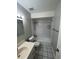 Bathroom with a tiled shower and bath combination with black and white floors at 4109 Fairview Vista Pt # 315, Orlando, FL 32804