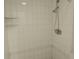 Close-up shot of a bathroom with an updated showerhead and wall tiles at 4109 Fairview Vista Pt # 315, Orlando, FL 32804