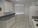 Efficient kitchen featuring white cabinets, a window with blinds, and modern appliances at 4109 Fairview Vista Pt # 315, Orlando, FL 32804