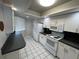 Bright white kitchen featuring modern appliances, tile floors, and ample cabinet space at 4109 Fairview Vista Pt # 315, Orlando, FL 32804