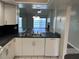 Kitchen sink and appliances, with a view of the living room and a fireplace at 4109 Fairview Vista Pt # 315, Orlando, FL 32804