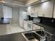 Bright kitchen with white cabinets, white appliances, and white tile floor at 4109 Fairview Vista Pt # 315, Orlando, FL 32804