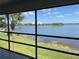 Screened porch view overlooking the lake and the blue sky with a palm tree to the left at 4109 Fairview Vista Pt # 315, Orlando, FL 32804