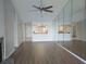 Bright open-concept living room with fireplace, wood flooring, and kitchen view at 4109 Fairview Vista Pt # 315, Orlando, FL 32804