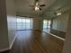 Bright living room boasts wood floors, a ceiling fan, sliding glass doors and a mirrored wall at 4109 Fairview Vista Pt # 315, Orlando, FL 32804