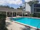 Community swimming pool offering ample seating, space for recreation, and palm tree accents at 4109 Fairview Vista Pt # 315, Orlando, FL 32804