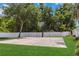 Outdoor basketball court featuring green grass, a tall white fence, and a basketball hoop at 453 Kays Landing Dr, Sanford, FL 32771