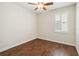 Bright bedroom featuring window with blinds, a ceiling fan, and wood-style flooring at 453 Kays Landing Dr, Sanford, FL 32771