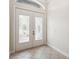 Inviting foyer featuring double doors with decorative glass and neutral-toned tile flooring at 453 Kays Landing Dr, Sanford, FL 32771