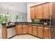 Kitchen with wooden cabinetry, granite countertops, and stainless steel appliances at 453 Kays Landing Dr, Sanford, FL 32771