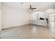 Open-concept living room with tile flooring, fan, and arched entryways at 453 Kays Landing Dr, Sanford, FL 32771